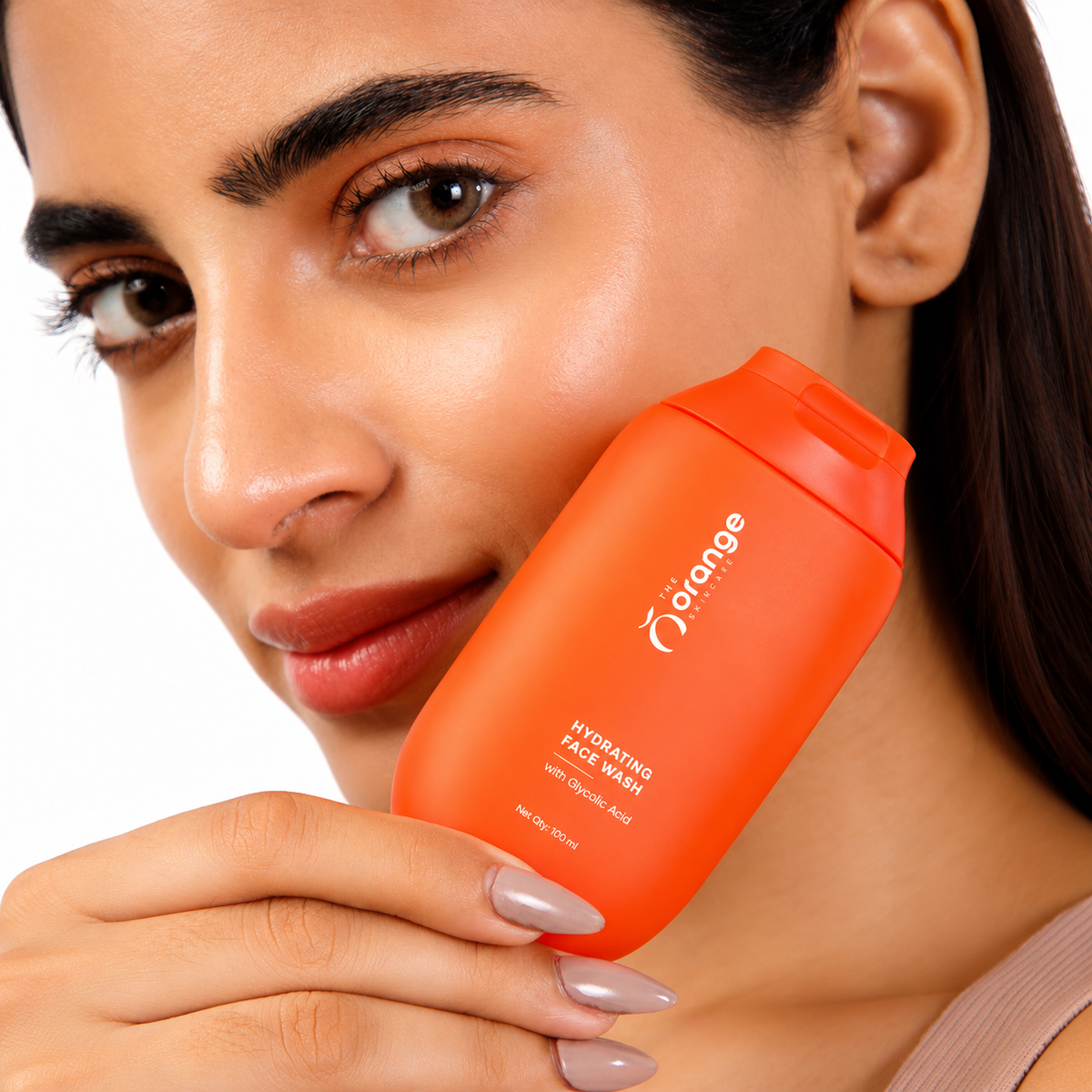 Woman holding Orange Skincare Hydrating Face Wash with Glycolic Acid