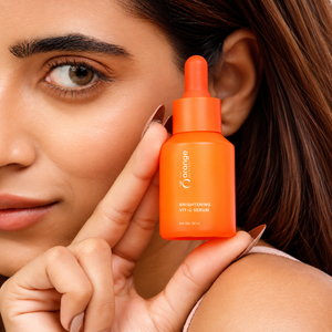 Woman holding Orange Skincare Brightening Vit-C Serum for her skincare routine